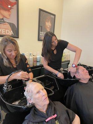 Maria and Salina giving shampoos and scalp massages.