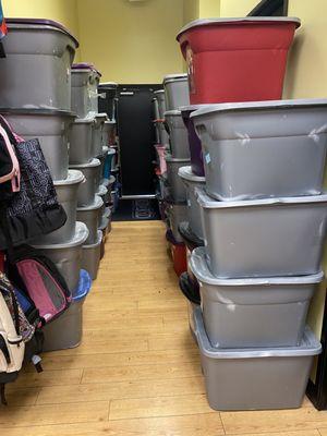 Storage bins they have to bring in/put out over stock in the hall where the emergency exit & restroom is. Stacked taller than me