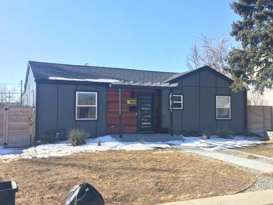 Hardie panel siding the Xtreme trim and a very modern pop with Tigerwood door box out and custom house numbers