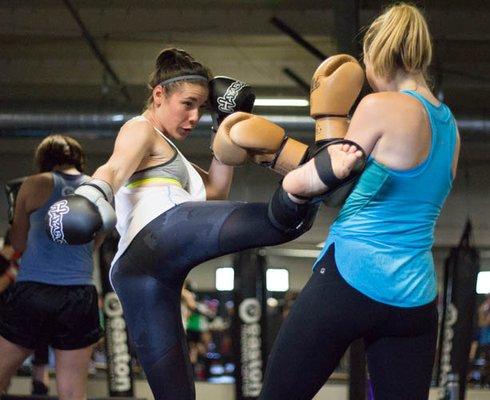 Throwing a round kick in Muay Thai