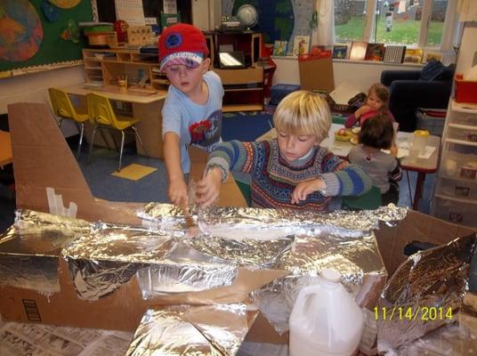 Children learn about airplanes while collaborating on a 3D jet