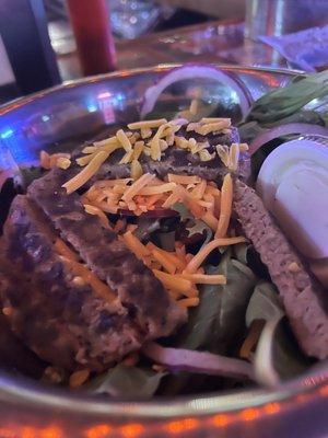 Salad with burger patty and avocado