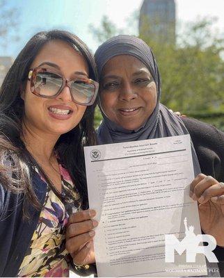 Moumita with her client after a successful naturalization interview.