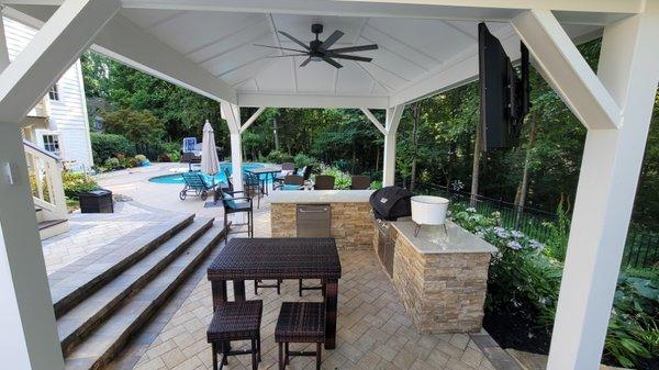 Pavilion + outdoor kitchen & bar + outdoor TV = the best place to hangout by the pool.