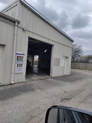 Entrance is behind the building jn the alley.