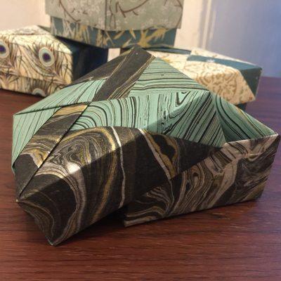 A box in marbled black and green, in an interesting pinwheel composition.