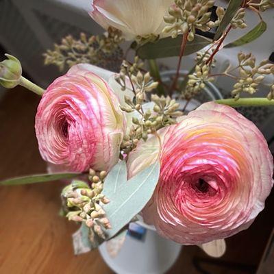 Ranunculus steams in a bid vase.