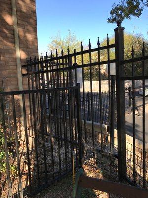 A man climbing over the gate.