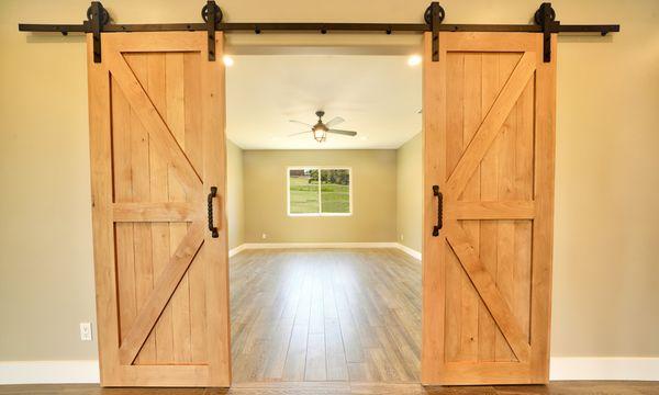 A welcoming, open office space with gorgeous barnyard doors for privacy and style.