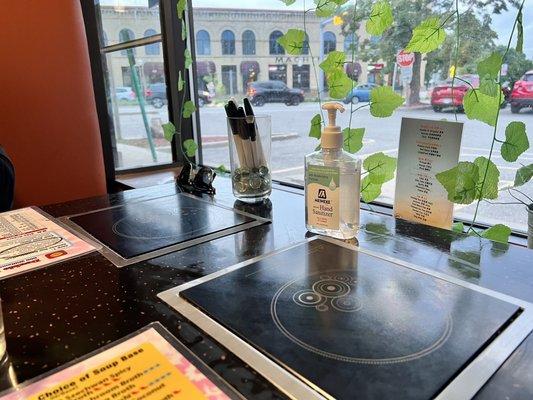 Sanitizer and markers to choose your food from the menu