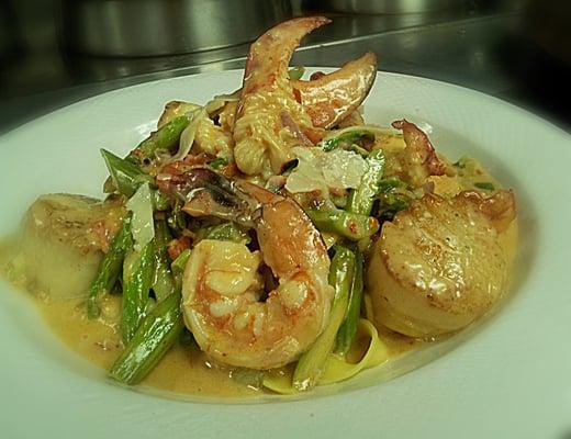 Shrimp, scallops, & lobster / sun dried tomato, asparagus over pappardelle