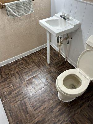 Replaced  warping plywood with stick in tiles & inserted new toilet