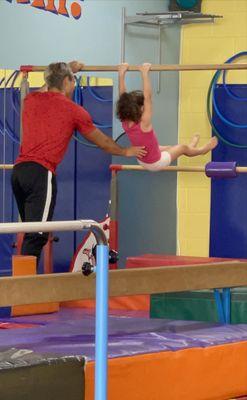 Coach Brian supporting my 5 YO through a routine.