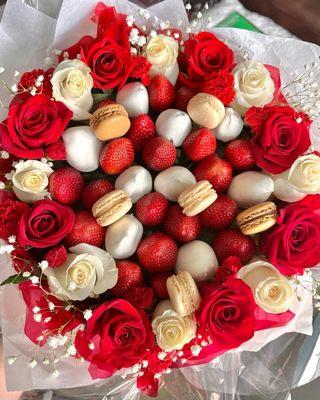 Beautiful arrangement with macaroons, strawberries, chocolate covered strawberries and fresh flowers