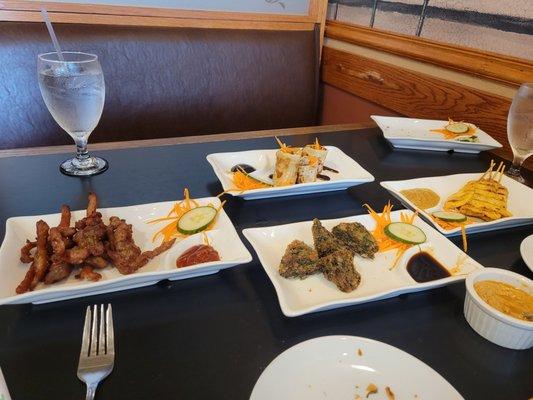 Tapas lunch spread. Duck rolls, pork jerky, chicken satay, and spinach triangle things