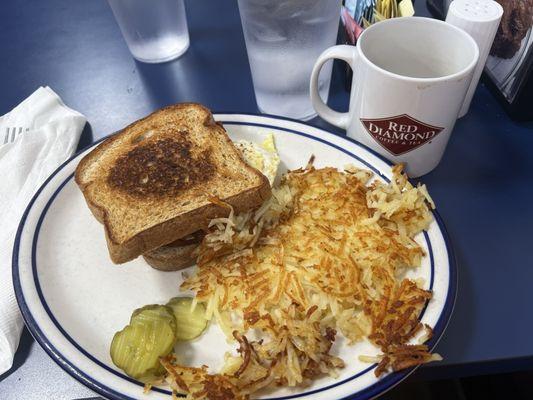 Bacon Egg and Cheese Sandwich on Wheat, served with hash browns, with Coffee