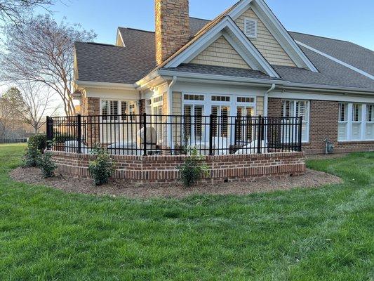 Back of patio with fence on top.