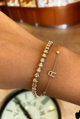 This yellow gold tennis bracelet is paired beautifully with a personalized initial bracelet!