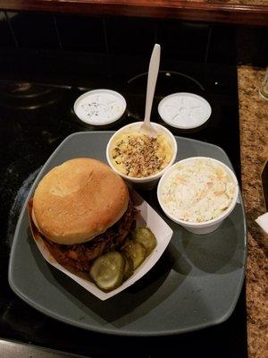 Pulled pork sandwich with some homemade pickles, mac n cheese, and cole slaw