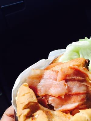 Raw bacon on sandwich