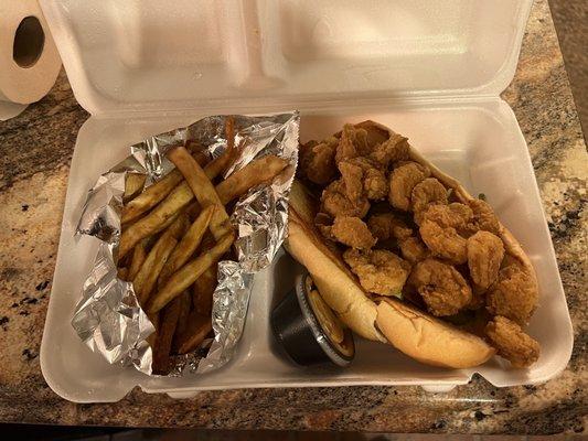 Shrimp po boy with fries.