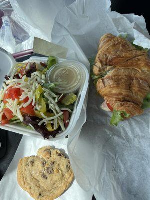 Chicken on croissant with green salad and chocolate chip cookie