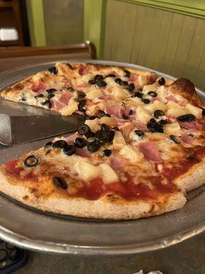 Ham, pineapple, black olive pizza