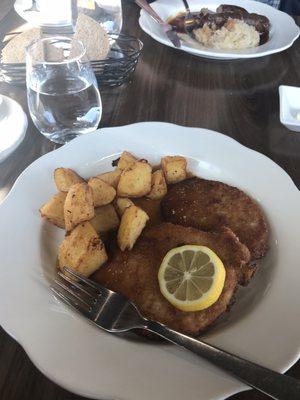 Schnitzel, potato's and gravy.  You can also see the Bratwurst, gravy and sauerkraut with potatoes.