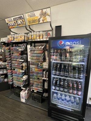 Paints and soda machine between the door and counter.