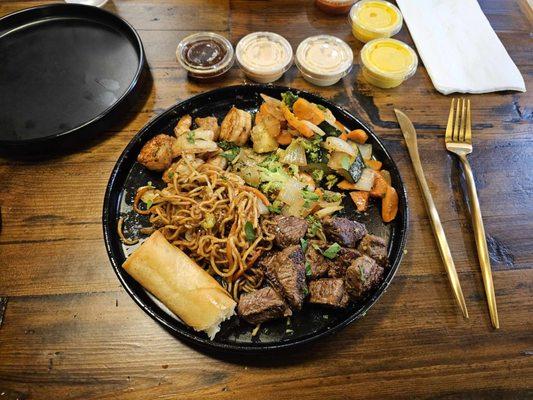 regular plate with filet steak, shrimp, spring rolls and veggies