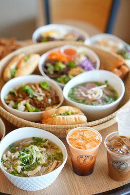 Pho, Fried Rice, and Salad Bowl, with drinks.