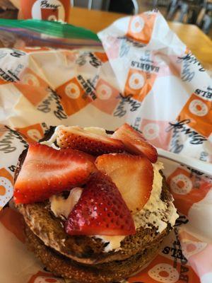 Pumpernickel bagel with strawberry cream cheese brought my own fresh strawberries