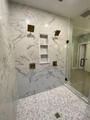 Master bathroom shower with 2 shower heads and large niche