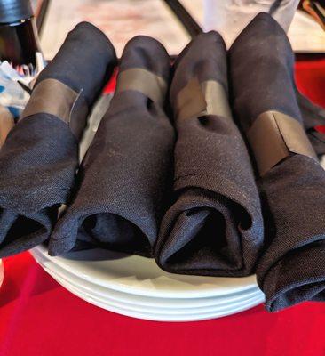 Napkins with utensils on small plates