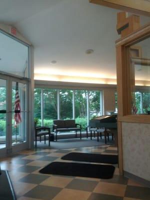 Entrance and part of the waiting room area; soothing tones of green, blue, and beige, plus lots of light from large windows