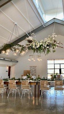 Kari did the large overhead floral focal point as well as greenery on the chandeliers.