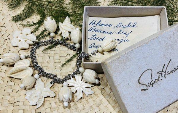 Antique Hawaiiana bone and sterling charm bracelet by Sigrid Hawai'i. Extremely rare example with original box.