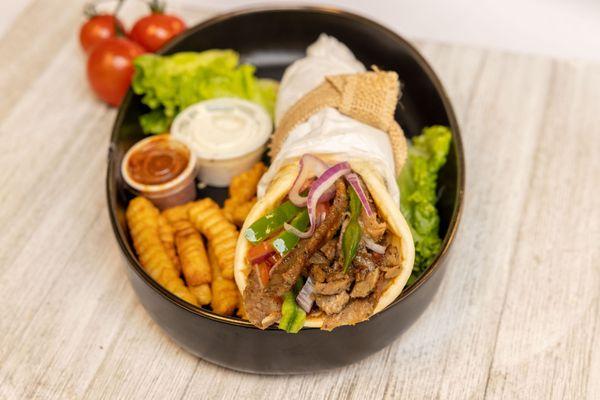 Lamb / Beef Gyro Wrap served on a fresh warm Pita and signature sauces