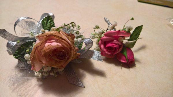 Mismatched pink corsages.  The bigger one is all brown encrusted.