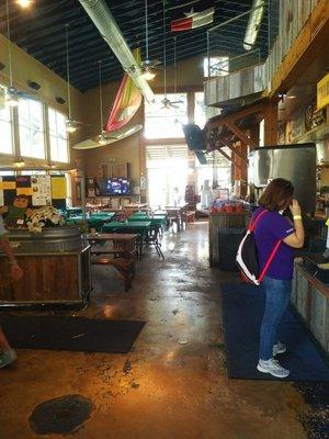 The women is standing in front of the registers/ walk in view