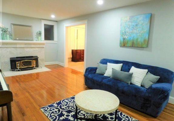 Finished cool-grey living room, with paper-white trim and baseboards