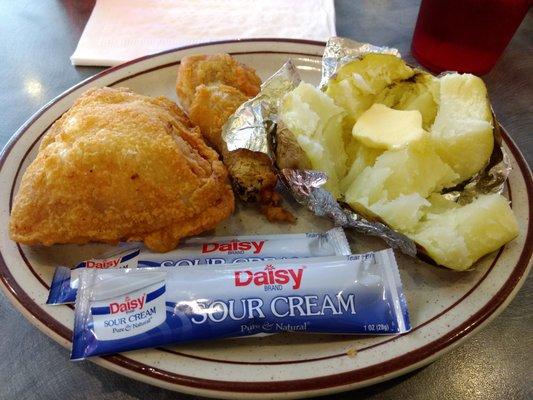 Broasted chicken with baked potato.