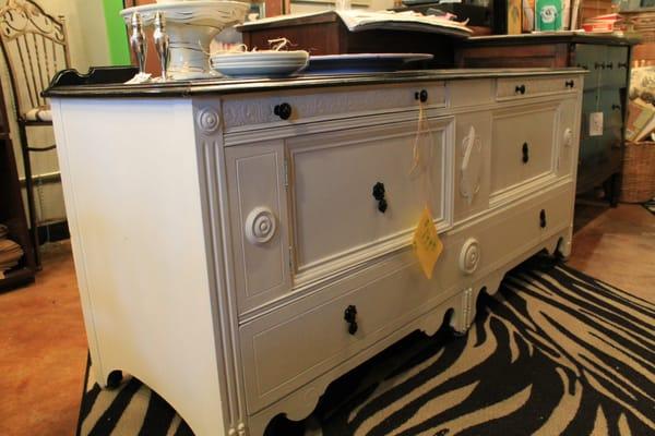 Antique Cabinet refurbished in a high white color with black hardware. The top serve area black and distressed. Sold for $199.00