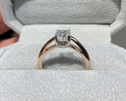 Contrasting rose and white gold solitaire, cushion cut diamond with hidden blue diamond in base of setting