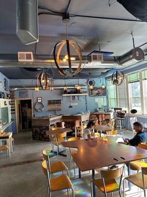 Inside brewery area to sit and enjoy a pint. Natural light fills the used to be school.