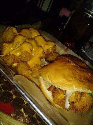 Chicken tenders sandwich with cheesy tots