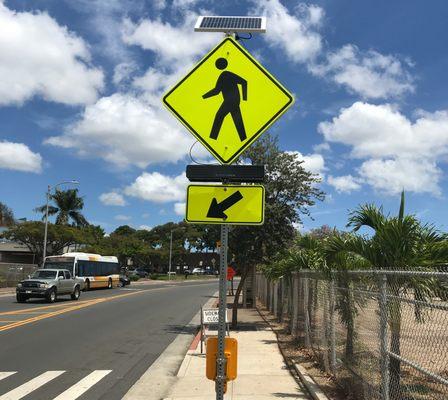 TraffiCalm RRFB crosswalk signal solar powered with blinking sign can be retrofitted to existing signs.