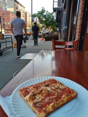 Square slice at an outside table on First Avenue $3.75