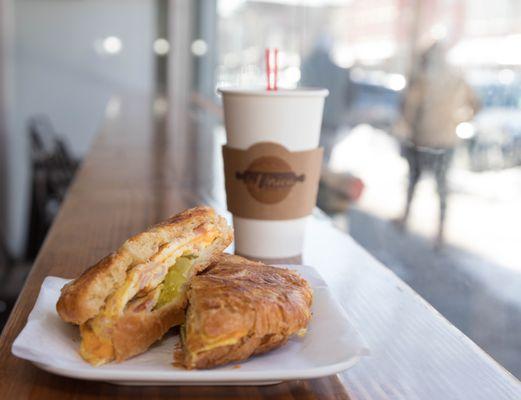 This is one of our Ham, Egg & Cheese Croissants breakfast sandwiches..  With a hot coffee.