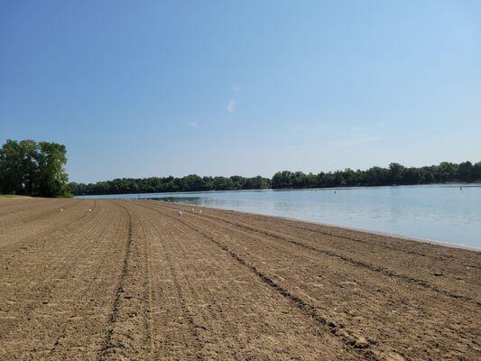 Peaceful beach, freshly combed and cleaned, in the morning